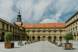photo of a courtyard with benches and a clock tower.jpeg